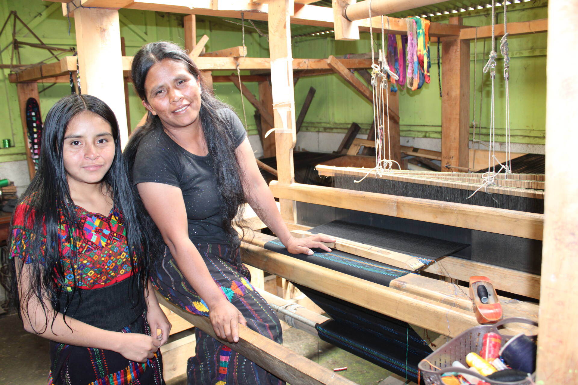 Regina e sua figlia ricamano i cortes, gonne tradizionali del loro villaggio in Guatemala